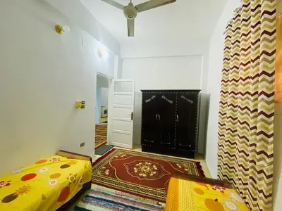 a room with a bedroom with a bed and a rug at Pharaoh apartment 2 in Luxor
