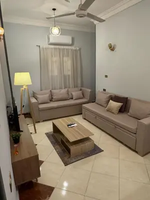 a living room with a couch and a coffee table at Cozy Retreat by The Sea in Safaga