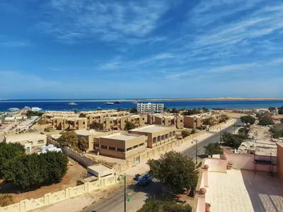 an aerial view of a city with the ocean at Cozy Retreat by The Sea in Safaga