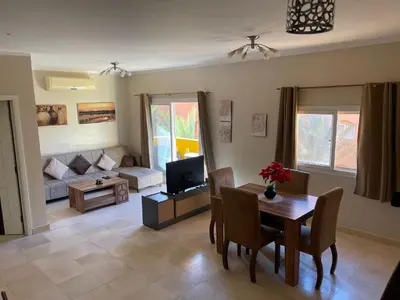 a living room with a table and a couch at Home from Home Al Dora Residence in Hurghada