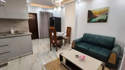 a living room with a green couch and a table at Stylish Sunny Central 1BR Apartment Hurghada in Hurghada