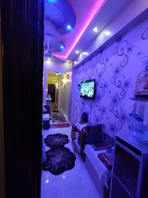 a room with purple lights and a room with couches at City centre Nile Breeze Aswan in Aswan