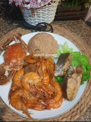 a plate of food with shrimp and bread on a table at City centre Nile Breeze Aswan in Aswan