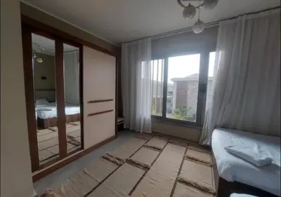 a bedroom with a mirror and a bed and a window at Apartment 3 Bedrooms Bali BR C1-D with Private Pool at Bali in Hurghada