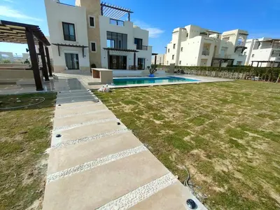 a backyard of a house with a swimming pool at Ancient Sand villa at Elgouna with private heated pool in Hurghada