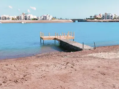 a dock in the middle of a body of water at Ancient Sand villa at Elgouna with private heated pool in Hurghada