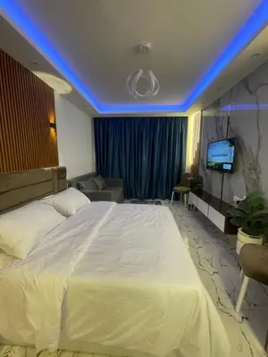 a bedroom with a white bed with a blue led ceiling at Oscar luxury N109Free WI-FI in Hurghada
