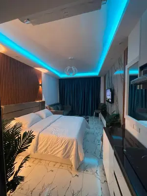 a bedroom with a large bed with blue lights at Oscar luxury N109Free WI-FI in Hurghada