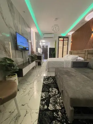 a hotel room with two beds and a flat screen tv at Oscar luxury N109Free WI-FI in Hurghada