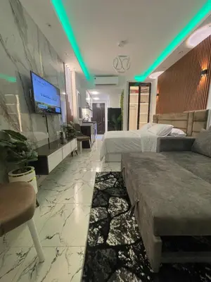 a hotel room with two beds and a tv at Oscar luxury N109Free WI-FI in Hurghada