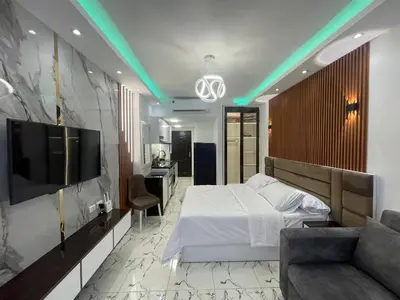 a bedroom with a bed and a tv and a couch at Oscar luxury N109Free WI-FI in Hurghada