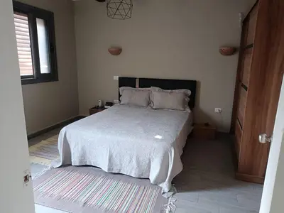 a bedroom with a bed in a room with a window at Bali-Style 1BR 10 Min 2 Downtown in Hurghada