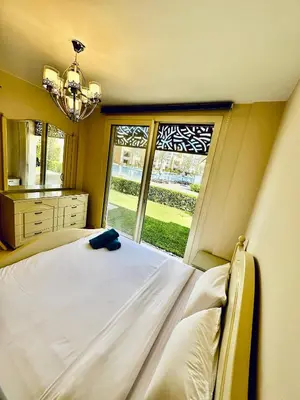 a bedroom with a large bed and a large window at 2 Bedrooms Ground Floor Pool view in Mangroovy Residence in Hurghada