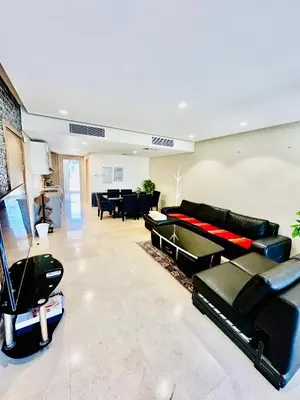 a living room with black leather furniture and a piano at 2 Bedrooms Ground Floor Pool view in Mangroovy Residence in Hurghada
