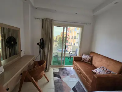 a living room with a couch and a large window at Florenza Khamsin bird in Hurghada