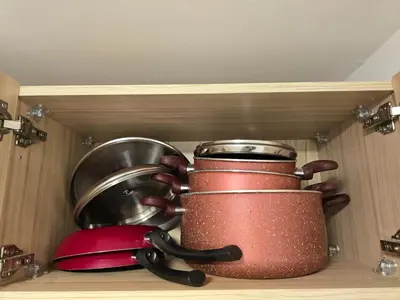 a shelf with pots and pans in a kitchen at Florenza Khamsin bird in Hurghada