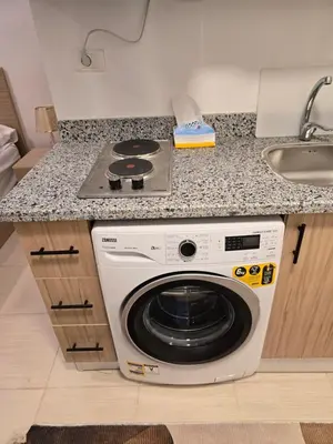 a kitchen with a washing machine and a sink at Florenza Khamsin bird in Hurghada