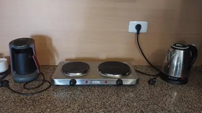 a stove with a blender and a coffee maker on a counter at Palma Resort A155 Chalet Hurghada in Hurghada