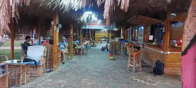 a group of people sitting at tables in a restaurant at Palma Resort A155 Chalet Hurghada in Hurghada