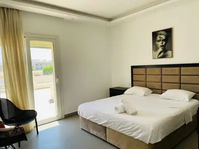 a bedroom with a large bed and a window at Luxury villa in gouna in Hurghada