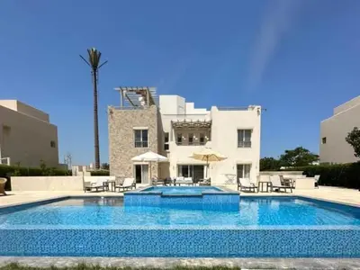 a large swimming pool in front of a building at Luxury villa in gouna in Hurghada