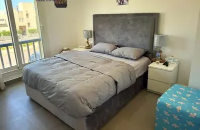 a bedroom with a large bed with a large window at Luxury villa in gouna in Hurghada