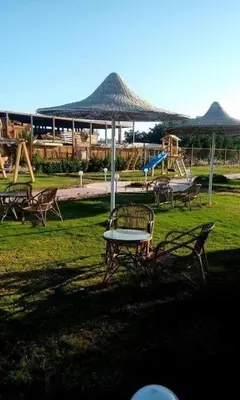 a park with a table and chairs and a playground at Fox Beach Inn in Hurghada