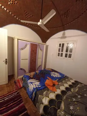 a bedroom with a bed and a ceiling at Mountain hug house in Luxor