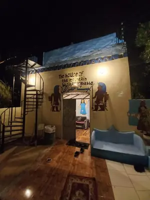 a building with a sign on the side of it at Mountain hug house in Luxor