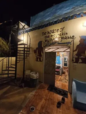a room with a wall with a sign on it at Mountain hug house in Luxor