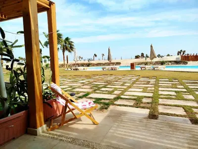 a chair sitting on a porch next to a pool at Tranquil escape in Hurghada