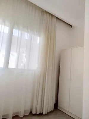 a white curtain in a room with a large window at Tranquil escape in Hurghada