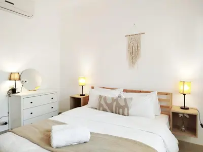 a bedroom with a large white bed and two lamps at Tranquil escape in Hurghada