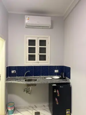 a kitchen with a sink and a window at Cozy Studio on Sheraton Road near Metro Market in Hurghada