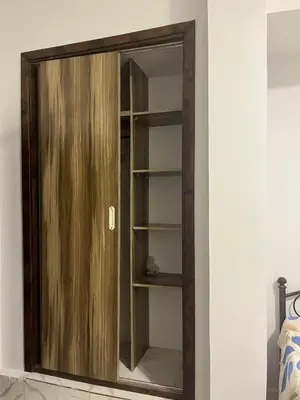 a mirror with a wooden door in a room at Cozy Studio on Sheraton Road near Metro Market in Hurghada