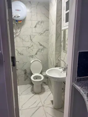 a bathroom with a toilet and a sink at Cozy Studio on Sheraton Road near Metro Market in Hurghada