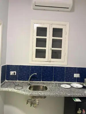 a bathroom with a sink and a window at Cozy Studio on Sheraton Road near Metro Market in Hurghada
