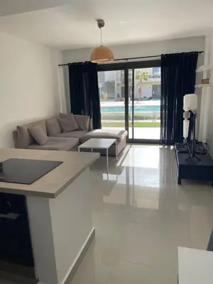 a living room with a couch and a table at GCribs in Hurghada