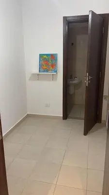 a bathroom with a toilet and a painting on the wall at GCribs in Hurghada