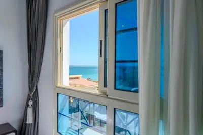 a room with a window with a view of the ocean at Strandapartment mit Meerblick & Pool im Juliana Beach Resort, Hurghada in Hurghada