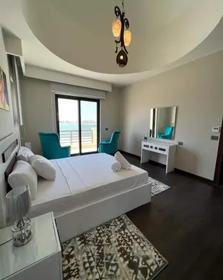 a bedroom with a large bed and a large window at Luxury villa in gouna in El Gouna