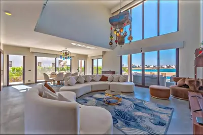 a large living room with white furniture and a pool at Luxury villa in gouna in El Gouna