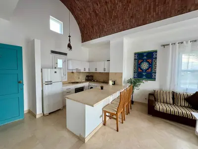 a kitchen with white cabinets and a blue door at G20-1-5 El golf in Hurghada