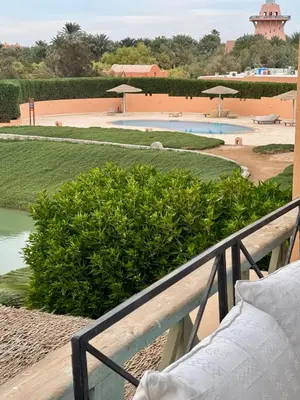a balcony with a view of a pool and bushes at G20-1-5 El golf in Hurghada