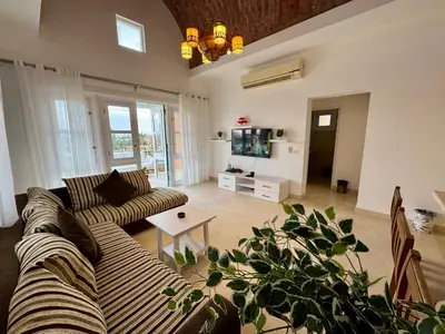 a living room with a couch and a tv at G20-1-5 El golf in Hurghada