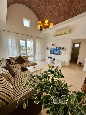 a living room with a couch and a table at G20-1-5 El golf in Hurghada