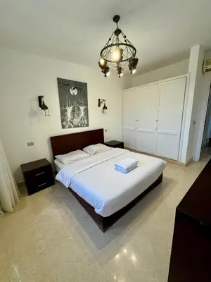a bedroom with a large bed and a chandelier at G20-1-5 El golf in Hurghada