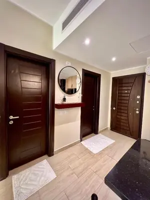 a bathroom with two brown doors and a mirror at Hurghada Stylish Heaven Luxury Apartment in Hurghada