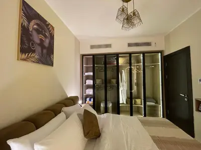 a bedroom with a bed and a closet at Hurghada Stylish Heaven Luxury Apartment in Hurghada