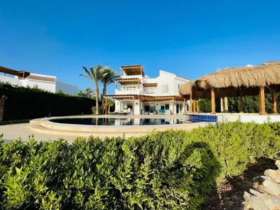 a large white house with a fountain in front of it at 5 bedroom villa with private pool at el gouna in Hurghada